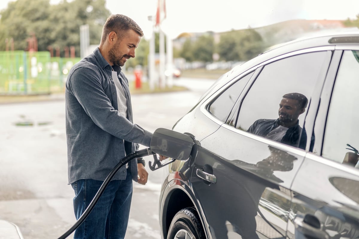 A commercial driver refueling a vehicle at a fuel station